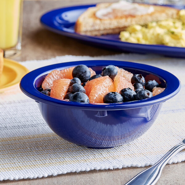 A blue Acopa Foundations melamine bowl filled with fruit including blueberries and grapefruit.