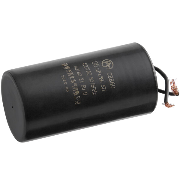A black cylindrical Estella running capacitor with writing on it.