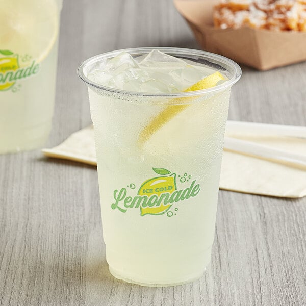 A plastic Carnival King lemonade cup filled with lemonade and a straw.