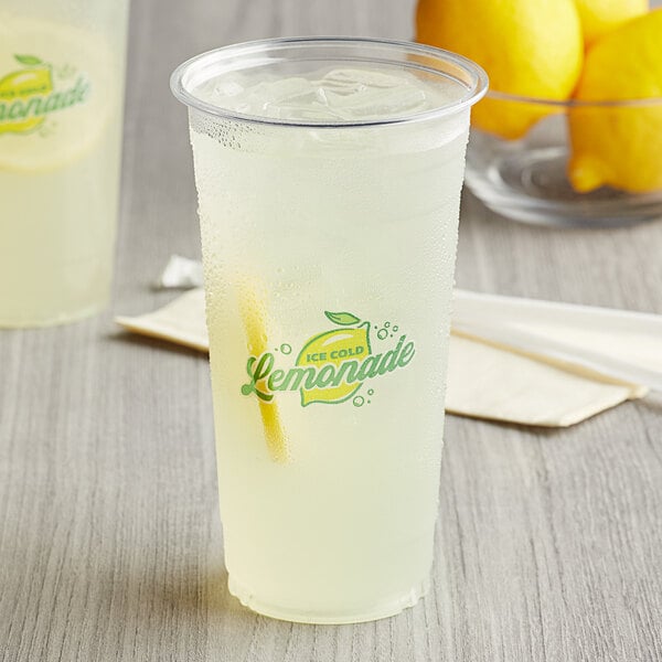 Two Carnival King clear plastic lemonade cups with lemonade and a straw.