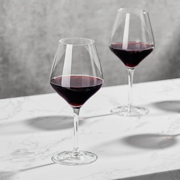Two Della Luce Astro red wine glasses on a table.