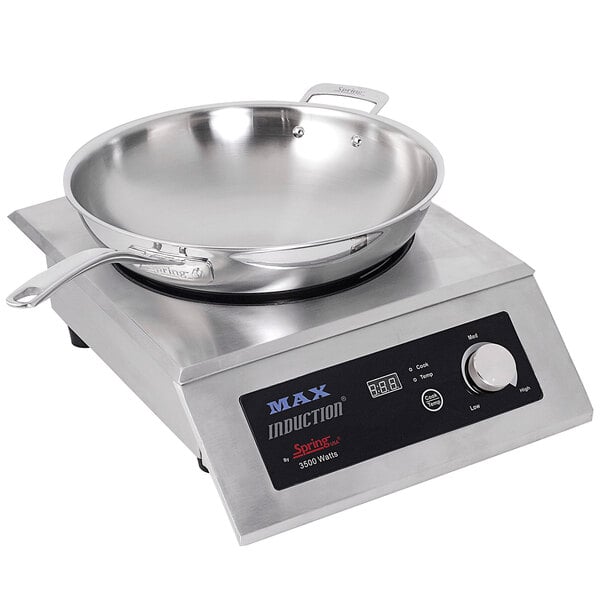 A Spring USA induction wok range with a Primo wok pan on top.