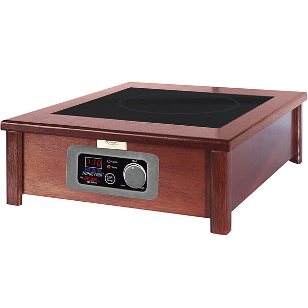 A Spring USA induction warmer in a wood cabinet with a SmartStone top.