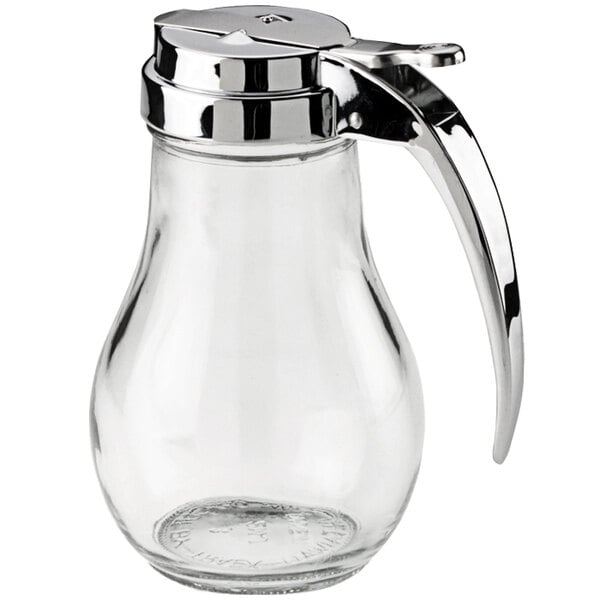A clear glass jar with a metal lid and handle.