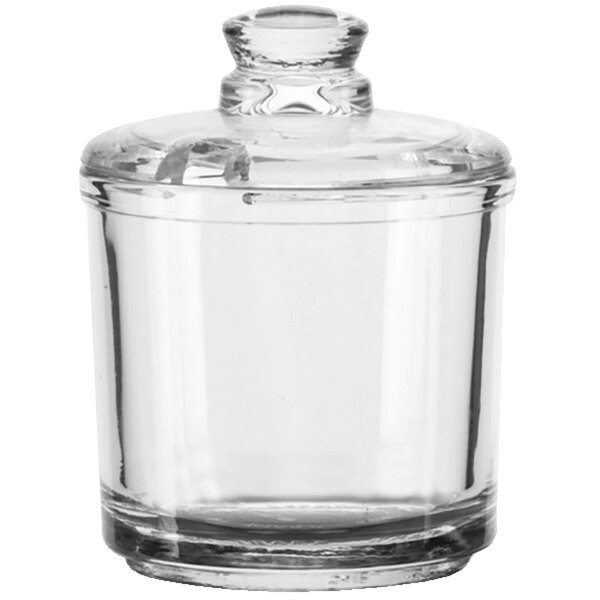 A clear glass Vollrath condiment jar with a lid.