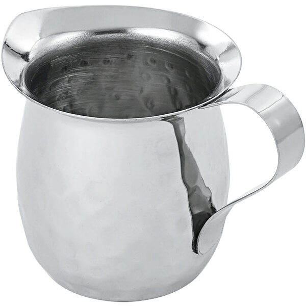 A Vollrath stainless steel bell creamer with a handle.