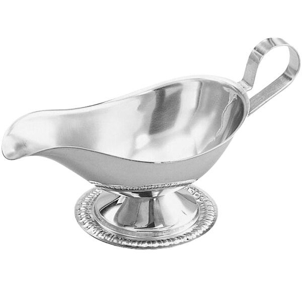 A silver stainless steel gravy boat.