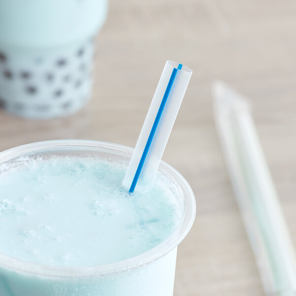 A cup of blue liquid with a Choice multicolor striped boba straw in it.