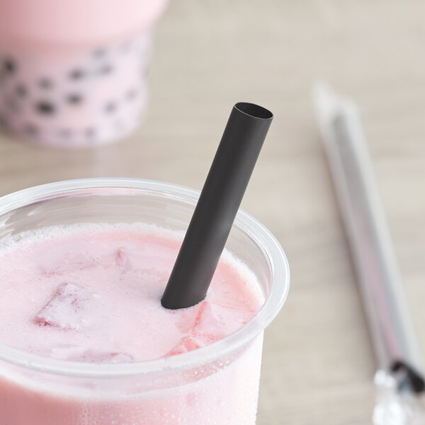 A pink drink in a cup with a black Choice boba straw.