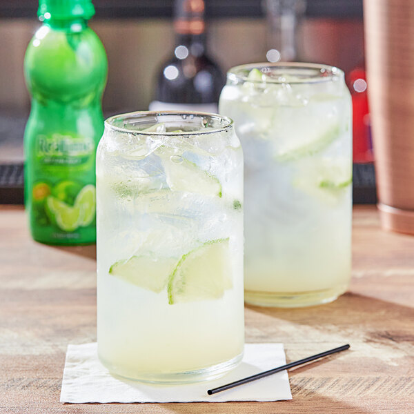 A glass of ReaLime lime juice with ice and lime slices.