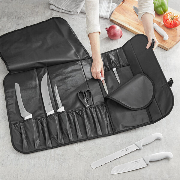 A woman holding a black Choice knife case with knives inside.