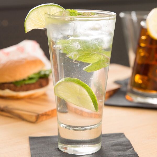 A Libbey highball glass filled with water, lime slices, and mint leaves.