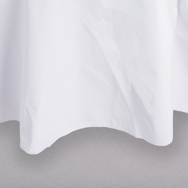 A white Intedge vinyl table cover with a flannel back on a table.