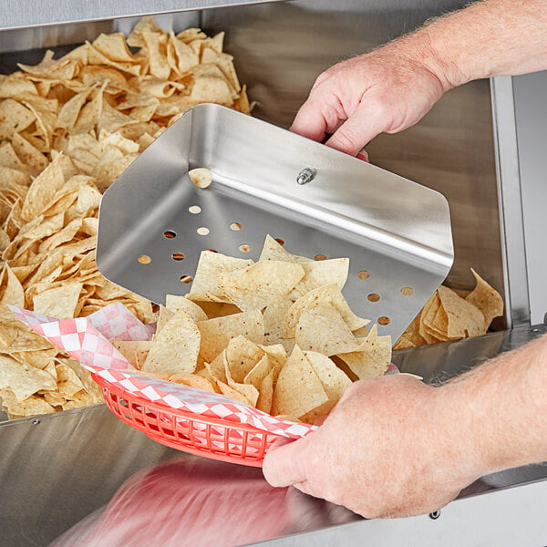 A person using a Choice stainless steel chip scoop to serve chips.