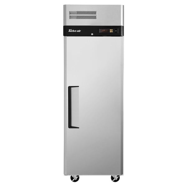A silver stainless steel Turbo Air reach-in refrigerator with a black handle on wheels.