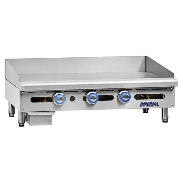 An Imperial Range stainless steel countertop liquid propane gas griddle with three burners.