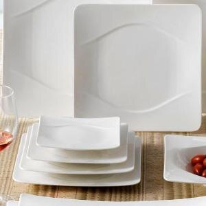 A stack of CAC Modern New Bone White Square Porcelain Plates and glasses.