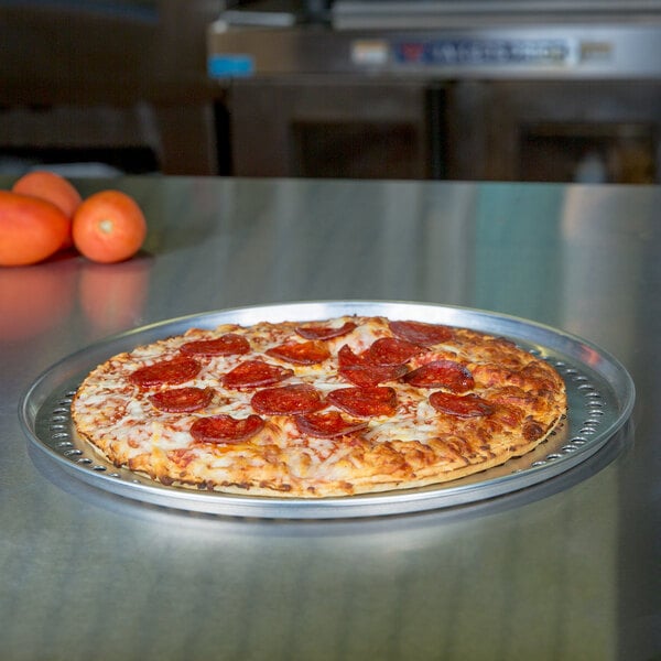 An American Metalcraft tapered aluminum pizza pan with a pepperoni pizza on it.
