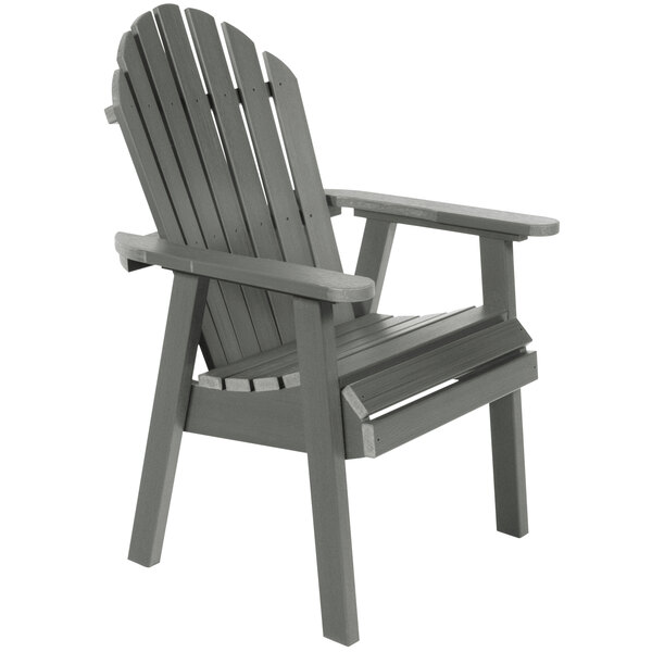 A grey faux wood adirondack chair with armrests.