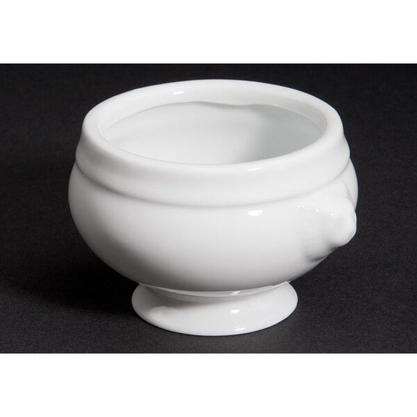 A close up of a white CAC porcelain lion head bouillon bowl.
