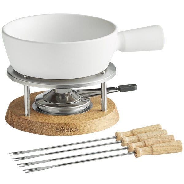 A Boska Bianco ceramic fondue set with a white bowl on a wooden stand.