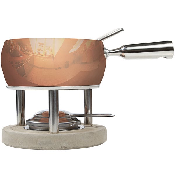 A Boska copper fondue pot on a stand.
