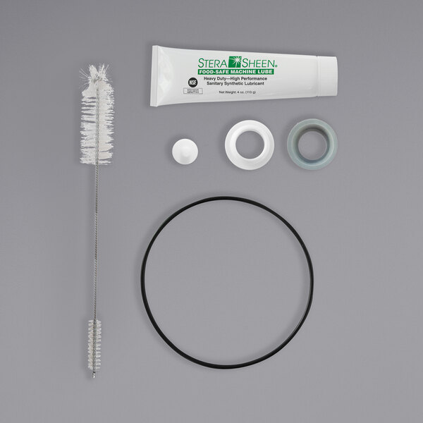 A SaniServ Tune-Up kit with white and black tubes on a white circle.