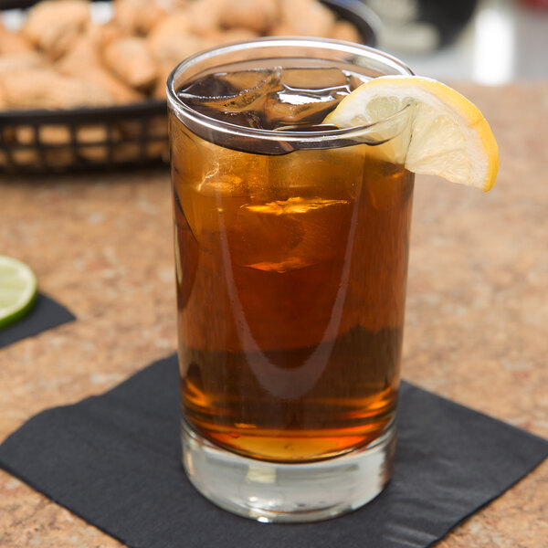 A Libbey Lexington beverage glass of iced tea with a lemon wedge.