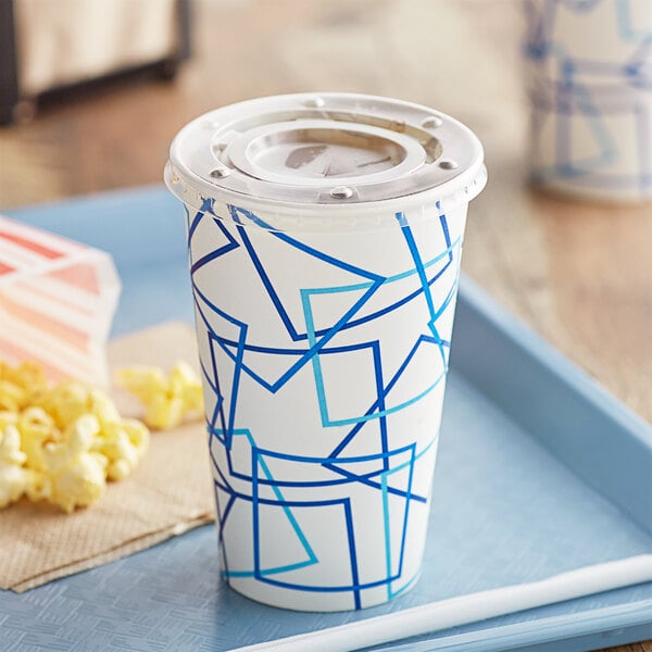 A white and blue Choice paper cold cup with a flat lid on a blue tray.