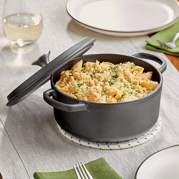 A Valor pre-seasoned cast iron pot of pasta with cheese and herbs.