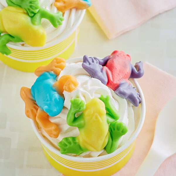 A cup of ice cream with Albanese Gummi Frogs on top.