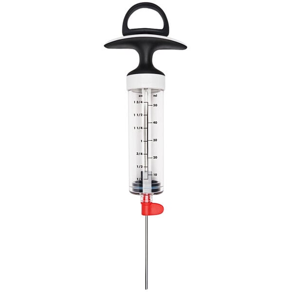 An OXO marinade injector with red and black handles.