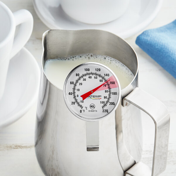 An AvaTemp frothing thermometer on a pitcher of milk.