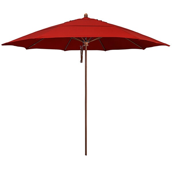 A close-up of a California Umbrella with a red Sunbrella canopy and wood pole.