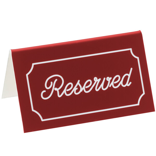 A red rectangular Cal-Mil tent sign with white "Reserved" text on it.