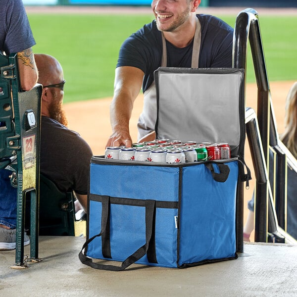 A man opening a Choice blue insulated cooler bag filled with cans of beer.
