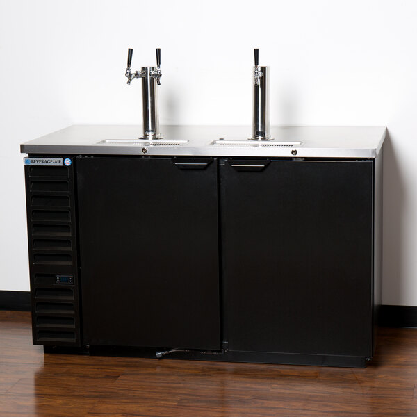 A black cabinet with a single and double wine keg taps on a counter.