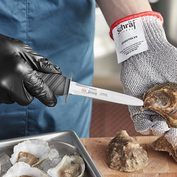 A person in gloves using a Schraf Galveston style oyster knife to shuck oysters.