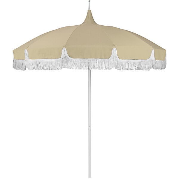 A tan umbrella with white fringe.