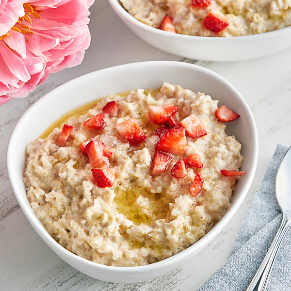 A bowl of Bob's Red Mill quick-cooking whole grain rolled oats with strawberries.