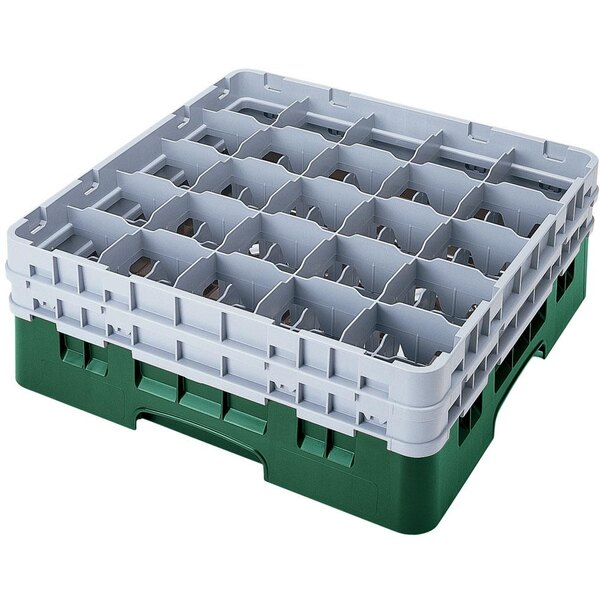 A white plastic Cambro glass rack with many green compartments.