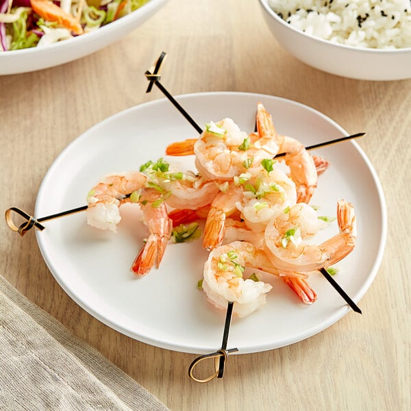 A white Riverstone melamine plate with shrimp skewers on it.