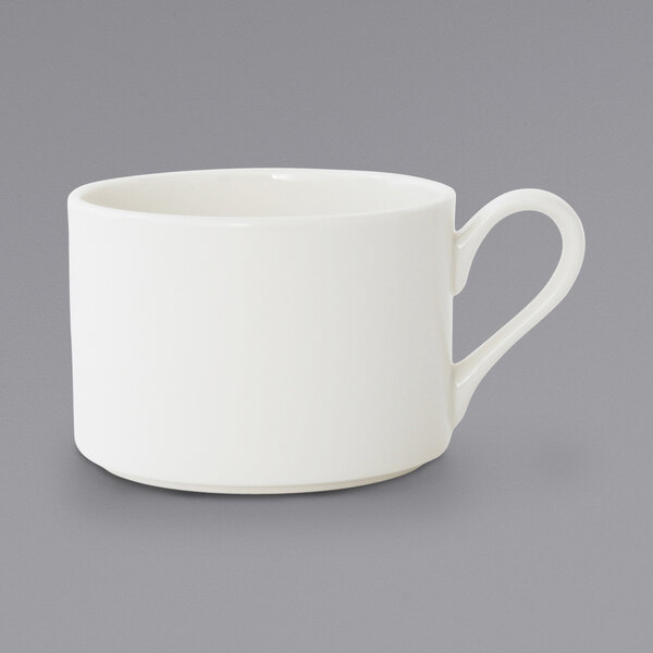 A close-up of a Fortessa Ilona bright white coffee cup with a handle.