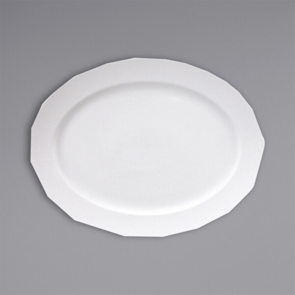 A close-up of a Fortessa Ilona white china platter with a wide rim on a gray surface.