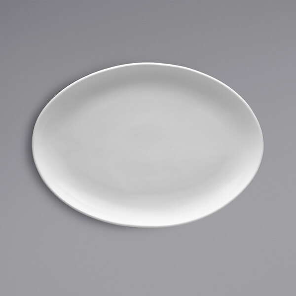 A white oval Fortessa china platter on a gray surface.