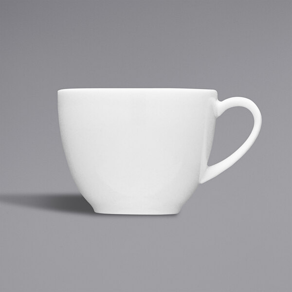 A close-up of a Fortessa bright white china espresso cup with a white handle.