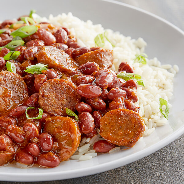 A plate of food with Goya Central American Red Beans, rice, and meat with sauce.