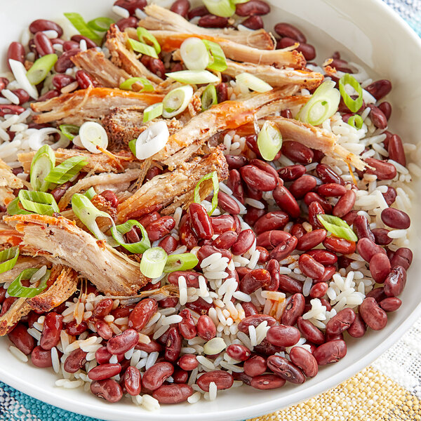 A bowl of rice and Goya small red beans with meat and onions.