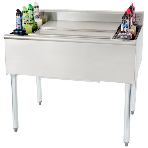 A stainless steel Eagle Group underbar cocktail and ice bin with a post-mix cold plate and eight bottle holders.