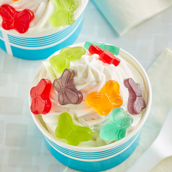A cup of ice cream with Albanese Mini Gummi Butterflies on top.